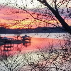 A picturesque scene of a serene lakeside at sunset